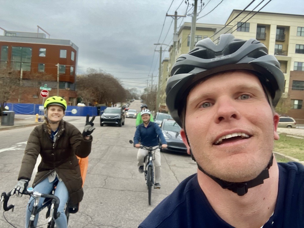 People riding bikes on a city street